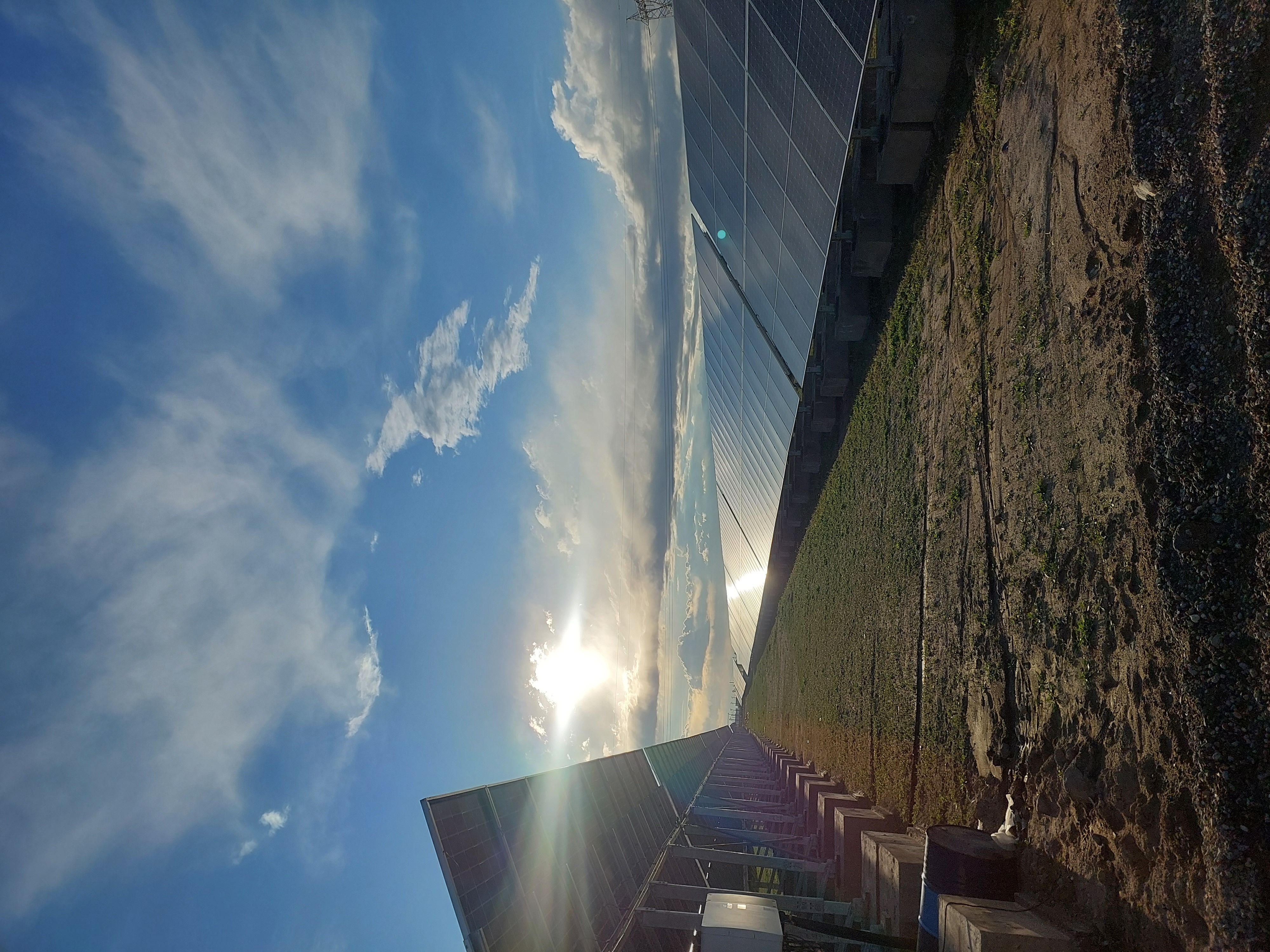 Sunlight between two rows of solar panels